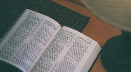 white book beside black table lamp