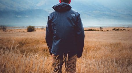 man in middle of wheat field