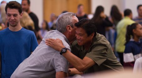 two men hugging on focus photography