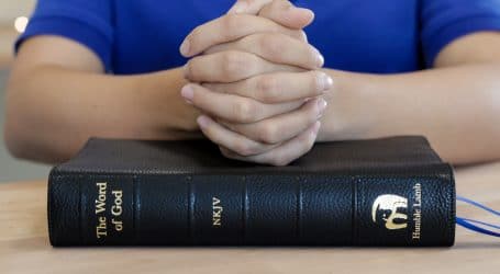 person infront of bible book