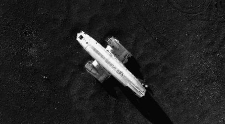white and black ship surrounded by body of water