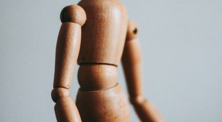 colse-up photo of brown wooden doll