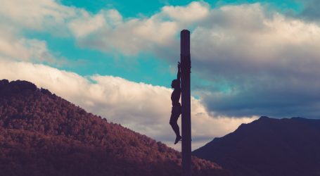 silhouette of crucified person during daytime