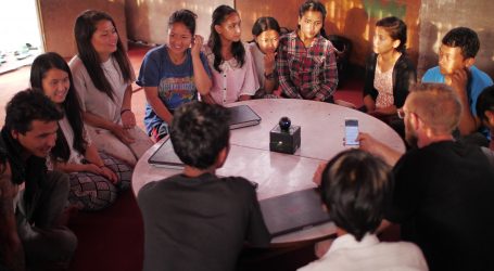 people sitting on floor front of table