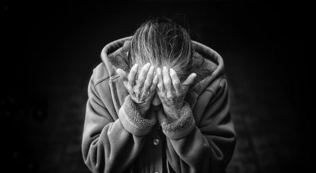 grayscale photography of person covering face