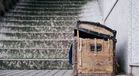 brown jewelry box beside concrete stairs