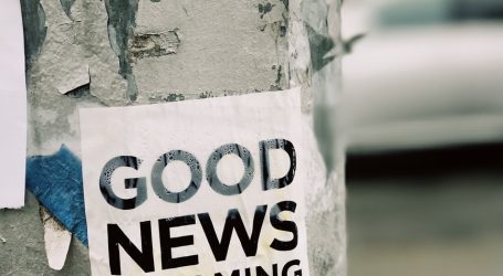 white Good News Is Coming paper on wall