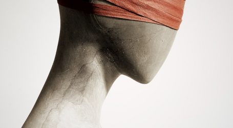 a white mannequin with a red band on its head