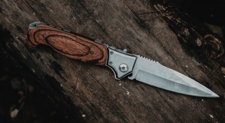 brown handle silver knife on brown wooden table