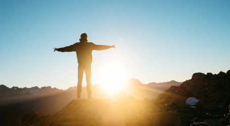 person standing on hill