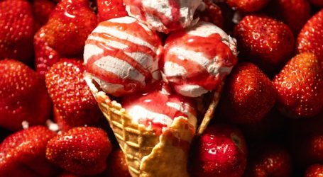 a pile of strawberries with a cone of ice cream