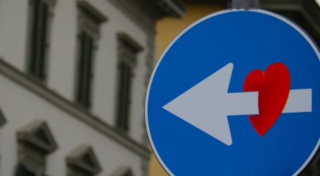 white arrow through red heart road signage