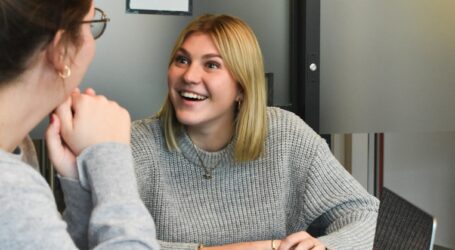 woman in gray sweater sitting beside woman in gray sweater
