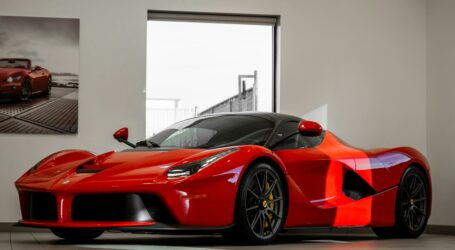 red ferrari 458 italia parked in front of white wall